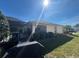 The backyard features a screened lanai, lush landscaping, and a well-maintained lawn at 4224 Hall St, Port Charlotte, FL 33948