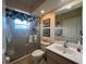 Bathroom featuring a shower with a floral curtain, toilet, and a sink with a large mirror at 4224 Hall St, Port Charlotte, FL 33948