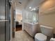 Bright bathroom features a vanity with storage, a toilet, and a shower, providing functionality and style at 4224 Hall St, Port Charlotte, FL 33948