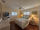 Bedroom with hardwood floors, fan, and a floral comforter, creating a cozy and inviting atmosphere at 4224 Hall St, Port Charlotte, FL 33948
