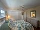 Bright bedroom with white closet doors, a fan, and a dresser adding storage space to the room at 4224 Hall St, Port Charlotte, FL 33948