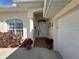 Inviting front entry with decorative plants, a covered porch, and a glimpse of the front door at 4224 Hall St, Port Charlotte, FL 33948