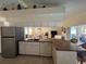 Open-concept kitchen features modern appliances and a breakfast bar with views of the living room at 4224 Hall St, Port Charlotte, FL 33948