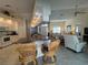 Open-concept living area features kitchen with bar seating and living room, perfect for entertaining at 4224 Hall St, Port Charlotte, FL 33948