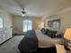 Comfortable main bedroom with a ceiling fan, hardwood floors, a large window, and natural light at 4224 Hall St, Port Charlotte, FL 33948