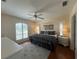 Comfortable main bedroom with a ceiling fan, hardwood floors, a large window, and natural light at 4224 Hall St, Port Charlotte, FL 33948