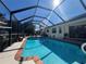 Screened-in pool with clear blue water and ample deck space for lounging and entertaining guests at 4224 Hall St, Port Charlotte, FL 33948