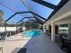 Screened pool with lounge chairs creates a relaxing outdoor space for enjoying the sun at 4224 Hall St, Port Charlotte, FL 33948