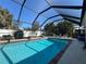 Screened pool with lounge chairs creates a relaxing outdoor space for enjoying the sun at 4224 Hall St, Port Charlotte, FL 33948