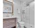 Modern bathroom features a wood vanity, stylish mirror and glass-enclosed shower at 425 Bristol Ct, Sarasota, FL 34237