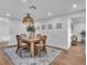 Bright dining room featuring an elegant woven chandelier, wood table and seating for four at 425 Bristol Ct, Sarasota, FL 34237