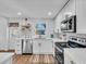 Well-lit kitchen with stainless steel appliances, white cabinets and light countertops at 425 Bristol Ct, Sarasota, FL 34237