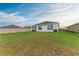 Well-maintained backyard with green grass and a view of the home's rear exterior at 4411 Hearthstone Run, Palmetto, FL 34221