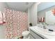 Clean bathroom featuring a toilet with a heart-themed curtain, and a well-lit vanity area at 4411 Hearthstone Run, Palmetto, FL 34221
