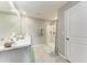 Bright bathroom featuring a shower with floral accents and a marble-look countertop at 4411 Hearthstone Run, Palmetto, FL 34221