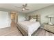 Cozy bedroom featuring a patterned bed, a modern ceiling fan, and a view to the other bedrooms at 4411 Hearthstone Run, Palmetto, FL 34221