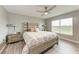 Relaxing bedroom showcasing a beautifully patterned bed, stylish lamps, and a bright, airy atmosphere at 4411 Hearthstone Run, Palmetto, FL 34221