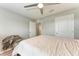 Neutral bedroom with a neatly made bed, ceiling fan, and a view out to the hallway at 4411 Hearthstone Run, Palmetto, FL 34221