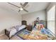 Bright bedroom featuring two twin beds with fun, colorful cartoon bedding and a modern ceiling fan at 4411 Hearthstone Run, Palmetto, FL 34221