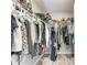 Organized walk-in closet featuring wood-look floors and ample storage space at 4411 Hearthstone Run, Palmetto, FL 34221