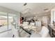 Bright dining area with a modern chandelier, glass top table and seating for six at 4411 Hearthstone Run, Palmetto, FL 34221