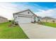 Charming single-story home featuring a manicured lawn and a two-car garage at 4411 Hearthstone Run, Palmetto, FL 34221