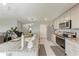 Kitchen island with granite counters, stainless steel appliances, and access to other living areas at 4411 Hearthstone Run, Palmetto, FL 34221