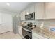 Modern kitchen featuring stainless steel appliances, granite countertops, and ample cabinet space at 4411 Hearthstone Run, Palmetto, FL 34221