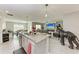 Open concept kitchen with stainless steel appliances, granite countertops, and view of the living room at 4411 Hearthstone Run, Palmetto, FL 34221