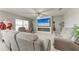 Bright living room with a decorative fireplace, large television, and comfortable gray seating at 4411 Hearthstone Run, Palmetto, FL 34221
