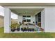Covered patio filled with potted plants and a sliding glass door leading inside at 4411 Hearthstone Run, Palmetto, FL 34221