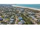 Aerial shot showcasing the home's proximity to the beach and lush surroundings at 462 Island Cir, Sarasota, FL 34242