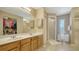 Spacious bathroom features dual sinks, a large mirror, ample cabinet space, and a glass-enclosed shower at 462 Island Cir, Sarasota, FL 34242