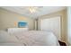 Comfortable bedroom with ceiling fan, television on top of dresser, and large closet at 462 Island Cir, Sarasota, FL 34242