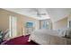 Bright bedroom with a ceiling fan, a dresser with a television, and a sliding glass door to the outside at 462 Island Cir, Sarasota, FL 34242