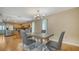 Inviting dining area featuring a modern table, stylish chairs, and an elegant light fixture open to the kitchen at 462 Island Cir, Sarasota, FL 34242