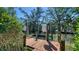 Private wooden dock with boat lift offering serene waterfront access and views at 462 Island Cir, Sarasota, FL 34242