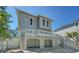 Angle view of two-story beach home featuring elevated deck and covered parking at 462 Island Cir, Sarasota, FL 34242