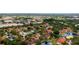 Aerial view of the community, showcasing lush landscaping, community pool, tennis courts, and serene ponds at 4655 46Th Street W Ct # 201, Bradenton, FL 34210