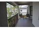 Balcony with a dark metal guardrail, trees, and a small table and chairs for relaxation at 4655 46Th Street W Ct # 201, Bradenton, FL 34210