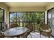 Relaxing screened balcony with table, chairs, and views of the surrounding green landscape at 4655 46Th Street W Ct # 201, Bradenton, FL 34210