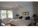 Comfortable bedroom with a ceiling fan, bright windows, and a cozy chair for relaxation at 4655 46Th Street W Ct # 201, Bradenton, FL 34210