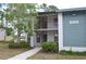Inviting condo building featuring a mix of neutral and blue siding with a charming balcony at 4655 46Th Street W Ct # 201, Bradenton, FL 34210