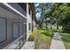 Charming condo exterior with screened patio, lovely landscaping, and a community walking path at 4655 46Th Street W Ct # 201, Bradenton, FL 34210