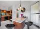 Cozy kitchen area with a granite-topped island and modern bar stool seating at 4655 46Th Street W Ct # 201, Bradenton, FL 34210