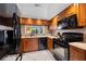 A well-appointed kitchen featuring updated appliances, granite countertops, and warm wood cabinetry at 4655 46Th Street W Ct # 201, Bradenton, FL 34210