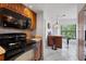 Well-equipped kitchen with a modern oven, granite countertops, and a stylish breakfast bar at 4655 46Th Street W Ct # 201, Bradenton, FL 34210