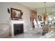 A living room featuring a fireplace, unique lighting, and white tile flooring, creating an inviting atmosphere at 4655 46Th Street W Ct # 201, Bradenton, FL 34210