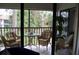 Enjoy the screened porch with comfortable wicker furniture and a peaceful outdoor view at 4655 46Th Street W Ct # 201, Bradenton, FL 34210