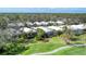 Community aerial view showing landscaped yards, tiled roofs, and screened lanais surrounded by greenery at 5003 88Th E St, Bradenton, FL 34211